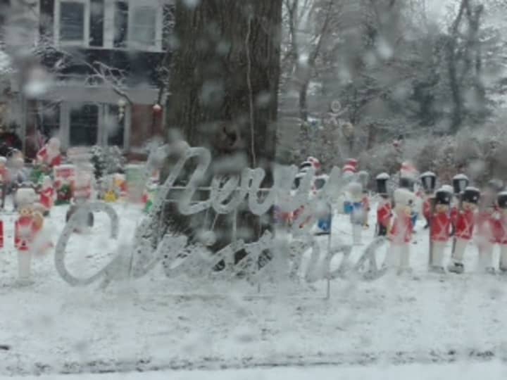 Snow covers a front lawn Christmas display in White Plains. 