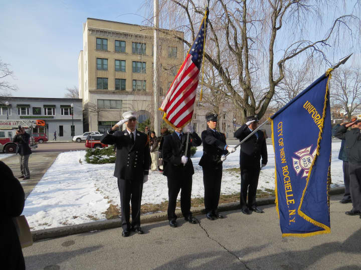 New Rochelle police salute the flag.