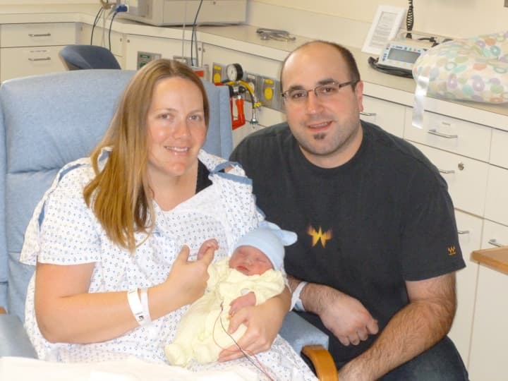Kirsten Tobler of Stamford holds her newborn son, Erik Lars, the first baby born at Norwalk Hospital in 2013. She is joined by her husband, Greg Tobler.