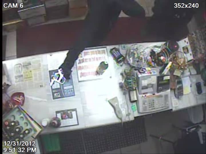 A security camera caught this image of a person with a revolver in the Hope Bottle Shop in Stamford on New Year&#x27;s Eve. 