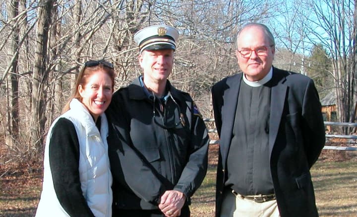 Dawn Egan, chair of the Weston Warm-Up Fund, Fire Chief John Pokorny and the Rev. Robert Ross, the new rector of Emmanuel Episcopal Church are ready for the annual Christmas tree bonfire.