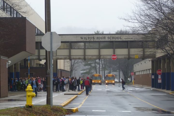Wilton Public Schools officials are reviewing security protocols a month after the tragedy at Sandy Hook Elementary School in Newtown. Some parents say the schools are safe, and they are not interested in armed guards. 