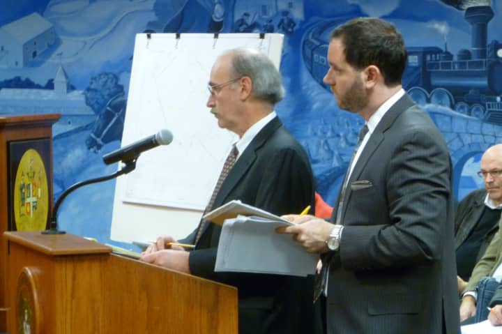 Thomas Heagney, attorney for Greenwich Reform Synagogue, left, and Mario Coppola, right, attorney for Cos Cob Resident Fighting For Residential Rights, listen to the Greenwich Planning and Zoning Commission during Tuesday&#x27;s meeting.