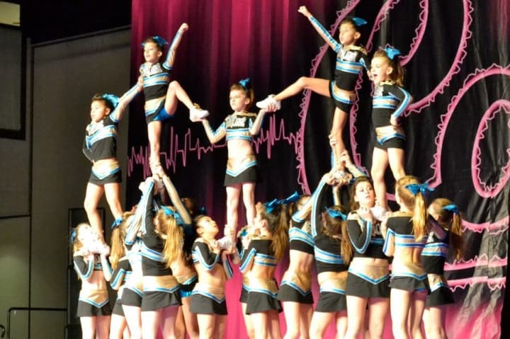 Members of the Mayhem team from Stamford-based Gold Coast All-Stars build a pyramid during a routine.