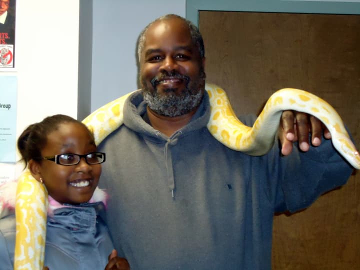 Larry Watts and his daughter Briana, 11, participate in the Fathers Count&#x27;s  Family Program Reptile Show in March 2012. Watts said participating in the program has helped to improve his relationship with his children. 