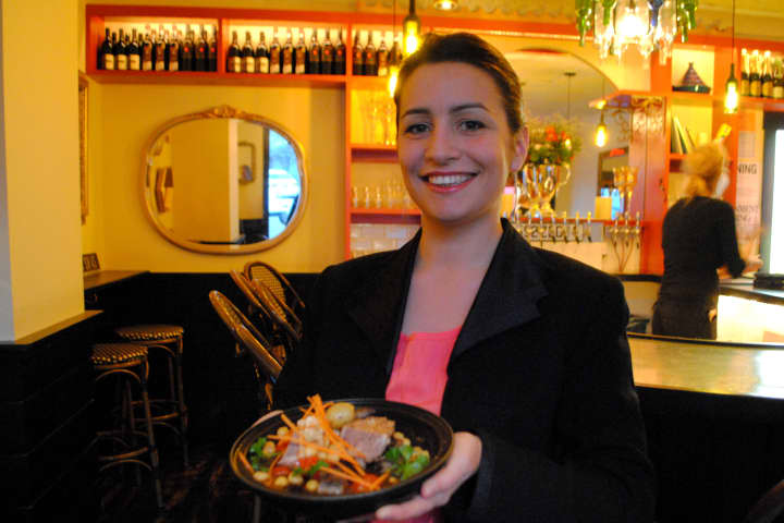Leila D&#x27;heurle stands with a short rib tagine in the bar area of Tagine. 