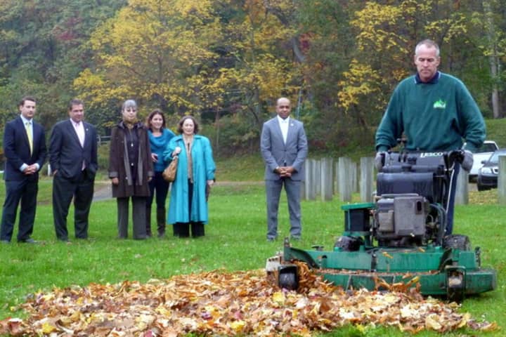 Tim Downey, owner of Aesthetic Landscape Care Inc., shows Yonkers officials how leaf mulching works during an October demonstration in Redmond Park. 