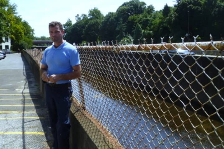 Ladovik Tinaj, assistant superintendent of the Yonkers complex, stands next to the flood barrier residents want to increase to 9.4-feet. 