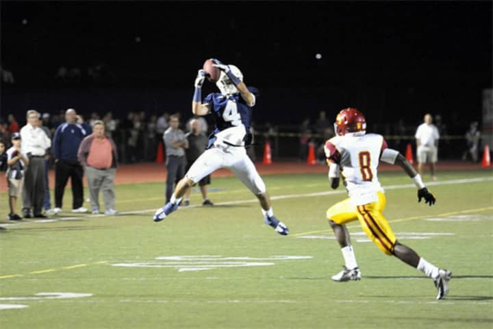 Staples wide receiver James Frusciante pulls in a pass during a game against St. Joseph last fall.
