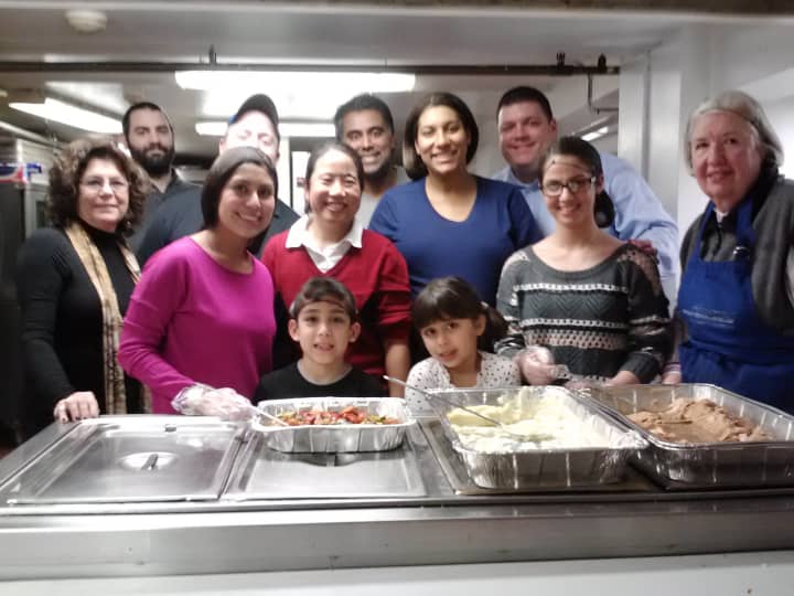 Employees of Axon Communications volunteered at a Mount Vernon soup kitchen on Thursday night.
