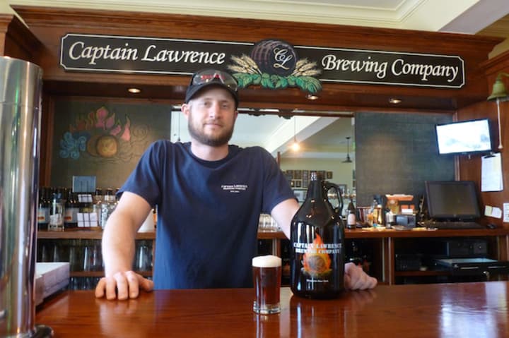 Ryan Kipp, a brewer at Captain Lawrence Brewing Company, stands with a sample of his new beer called &quot;The Pride of Elmsford.&quot;
