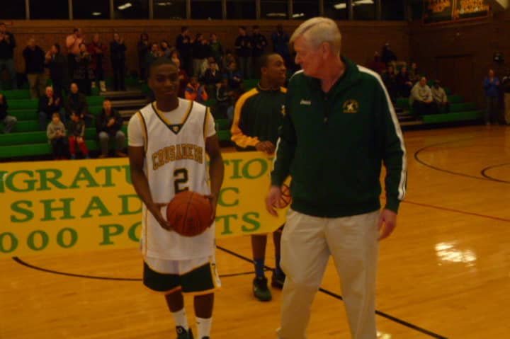 Trinity Catholic&#x27;s Schadrac Casimir, left, receives a ball for scoring his 1,000th-career point from Mike Walsh before Friday&#x27;s game against Danbury.