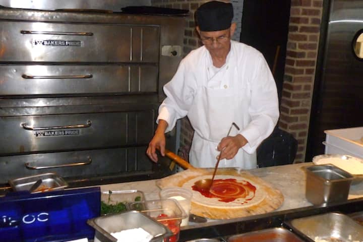 Tony Diaz spreads sauce on pizza dough at Racanelli&#x27;s New York Italian, 851 Central Park Ave., in Greenburgh.