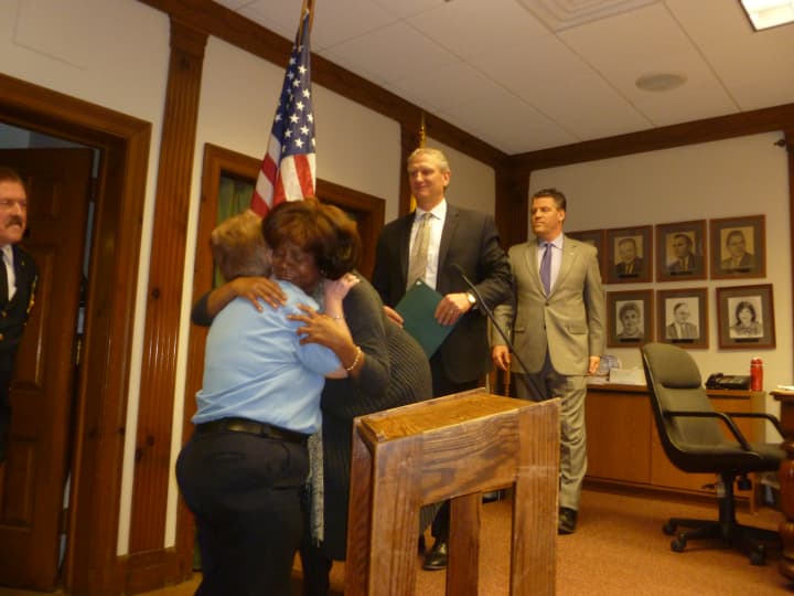 Fran Perito, an office assistant with the Yorktown Police Department, gets a hug from Town Clerk Alice Roker.