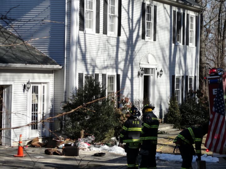 Members of the Pleasantville Fire Department assess the damage done at the Chestnut Street home. 