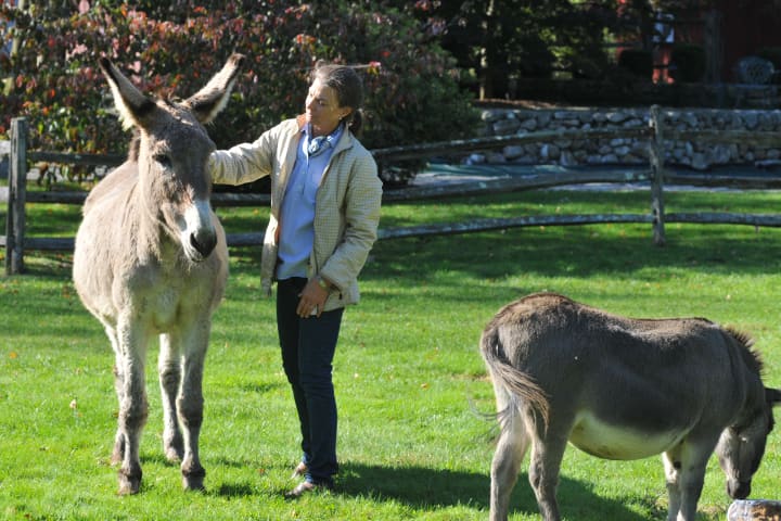 Bethany Zaro, of North Wilton Road in New Canaan, with her donkeys Poppy, left, and Chipper. 
