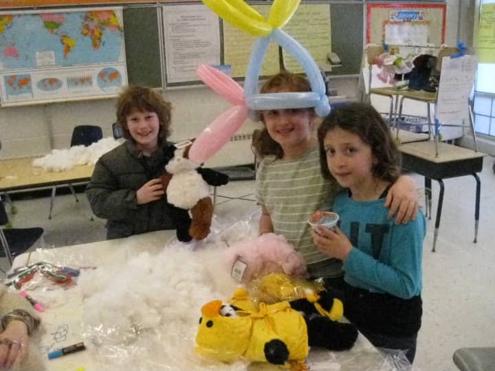 From left, Spencer Nyitray, Jenna Luper and Samantha Luper took some time building stuffed animals at the &quot;Cuddly Friends&quot; station at the Lewisboro Circus.