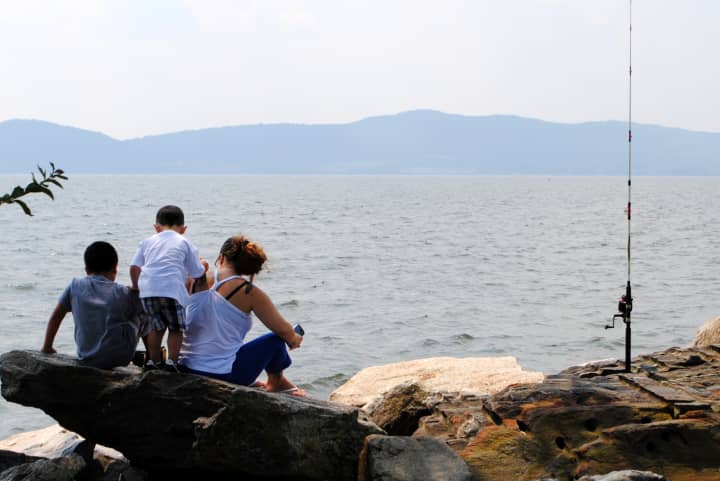 A family fishing along the Hudson River in Croton, where signs warning about the dangers of eating fish from the river could soon be placed.