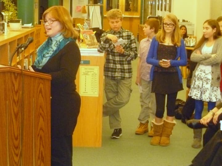 John Jay Middle School teacher Laura Atwell explains the 26-Day Challenge to the Board of Education as some of the students who participated look on.