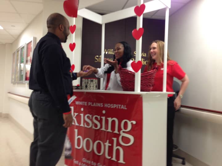Nurses give Jermaine Barnett, office assistant at White Plains Hospital, dark chocolate kisses as part of the hospital&#x27;s Go Red Campaign.