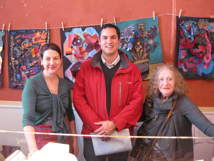 Plum Plums owner Audrey Free, left, stands with Pound Ridge Elementary art teacher David Llanos, and local artist Lisl Steiner, who curated the art show.