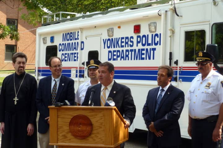 Residents have given an outpouring of support to keep Fourth Police Precinct Capt. John Mueller (third from left) at his position. Mueller joined city officials in Trinity Plaza in August for the launch of a neighborhood cleanup program. 