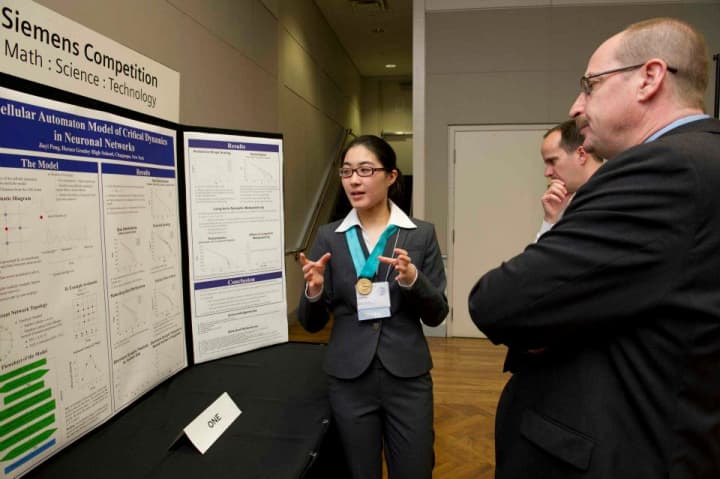 Horace Greeley senior Jiayi Peng, left, presents her cellular automation model for critical dynamics in neuronal networks project in the Intel Finals in Washington D.C. next month.