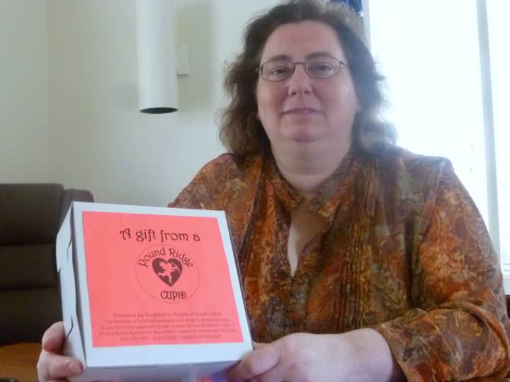 Louise Paolicelli, Pound Ridge  coordinator os senior programs, with one of the Project Pound Ridge Cupid gift boxes.