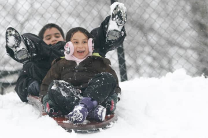 Norwalk Mayor Richard Moccia declared a snow emergency in Norwalk Friday. Dani Hernandez, front, and Jacob Benitez are shown enjoying the snow in a previous storm.