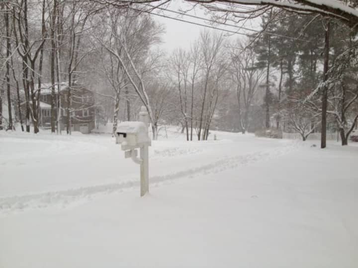 Few cars used village streets Friday afternoon in Briarcliff Manor as the snow piled up. 