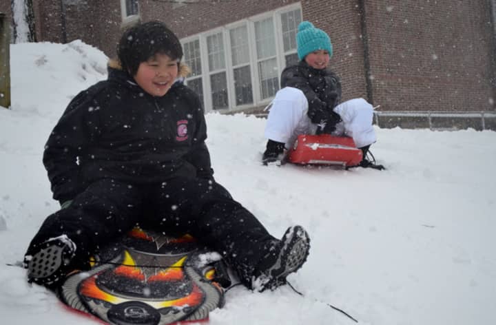 Children go sledding at Greens Farms School in Westport Friday afternoon. 