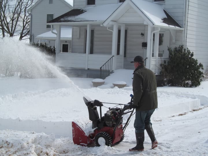 A helpful Danbury man snow-blows a neighbor&#x27;s sidewalk on Saturday morning.  