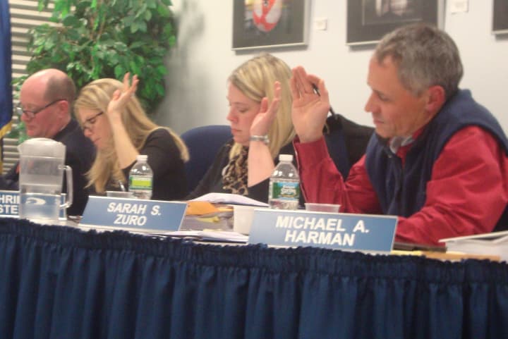 Darien Board of Education members vote to approve the $83,224,929 budget for the 2013-14 school year.