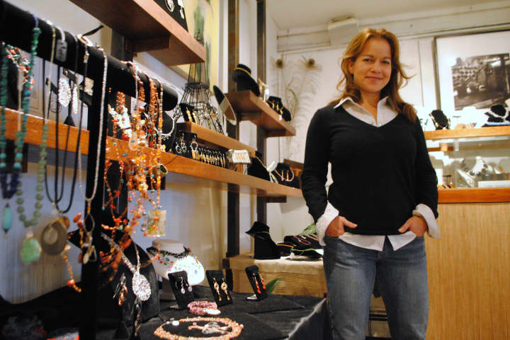 Jennifer Rutheny stands by some of the work of invited jewelers, in her shop. 