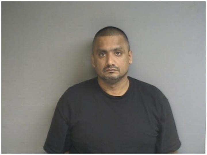 Gajesh Sewnarain, 49, was charged with embezzling and seven counts of criminal impersonation, police said. 