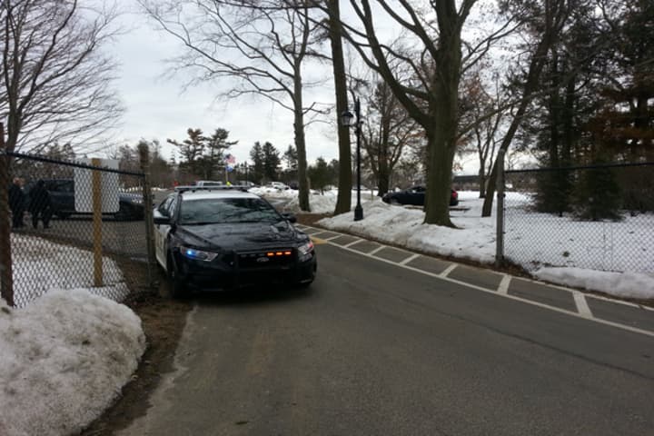 A Westport Police car sits outside an entrance to Greens Farms Academy Friday following a school-wide lockdown.