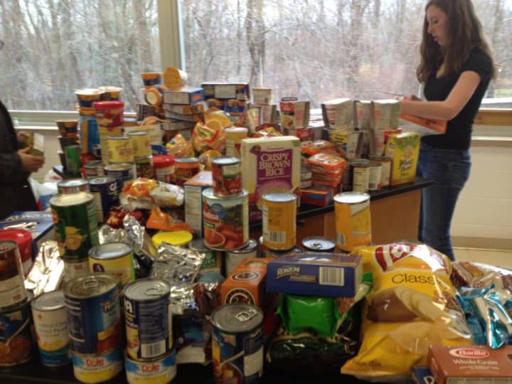 Junior Katie Ryan sorts through nonperishable food donations.
