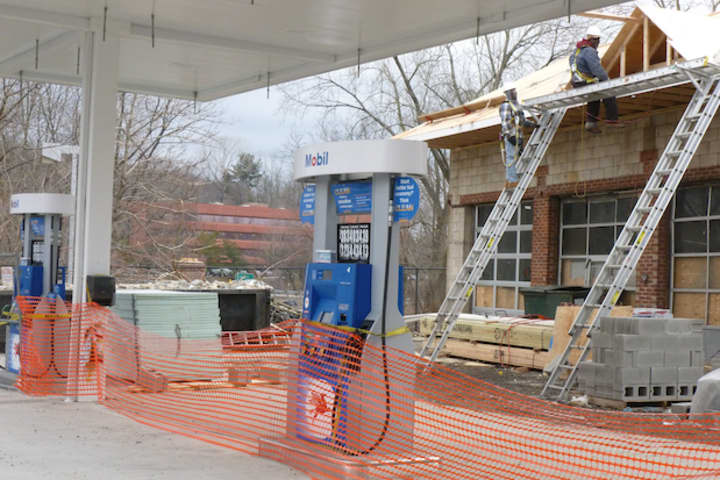 Construction workers are converting the 3-door garage into a convenience store for a new Mobil station on Knollwood Road in Greenburgh.