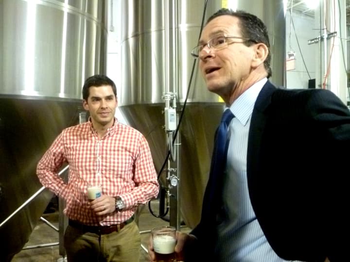 Gov. Dannel Malloy tries a fresh glass of Half Full Brewery&#x27;s Bright Ale with Owner Conor Horrigan Monday afternoon in Stamford. 