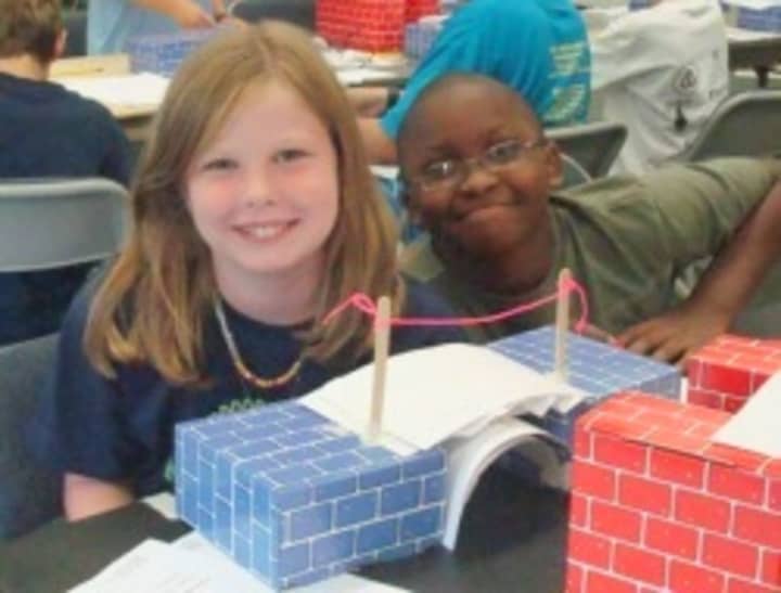 Young engineers with their bridge designs.