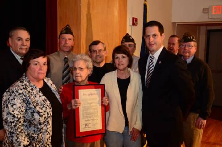 Robert Perry&#x27;s daughter, front left, and wife, holding the plaque, accepted the induction on behalf of the late Yorktown World War II veteran.