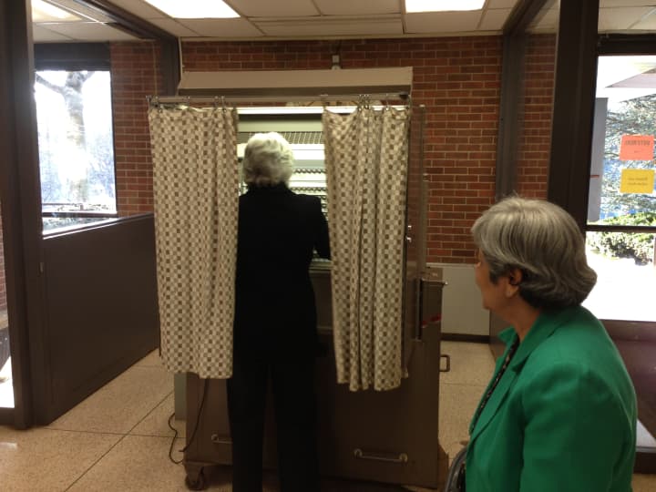 Carolyn Steigmeier, a longtime election inspector, votes Tuesday in Scarsdale. 