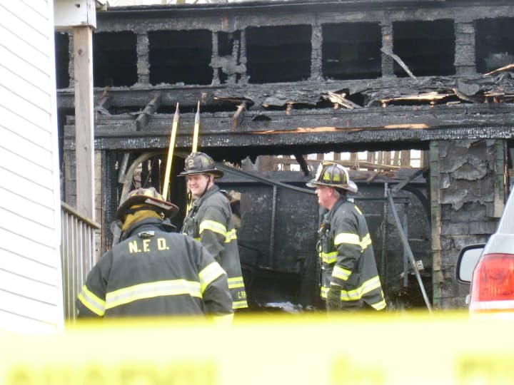 Norwalk firefighters doused a detached garage fire at 42 Woodward Ave. Wednesday morning. One person was injured in the blaze, and one was being questioned.