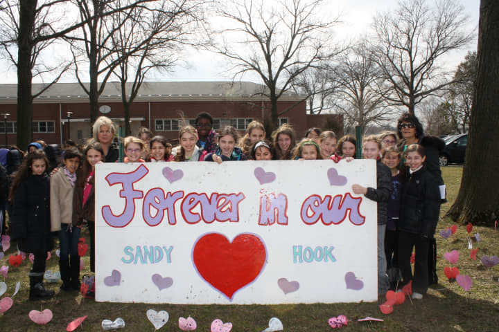 Eastchester students pose with the hearts they decorated.