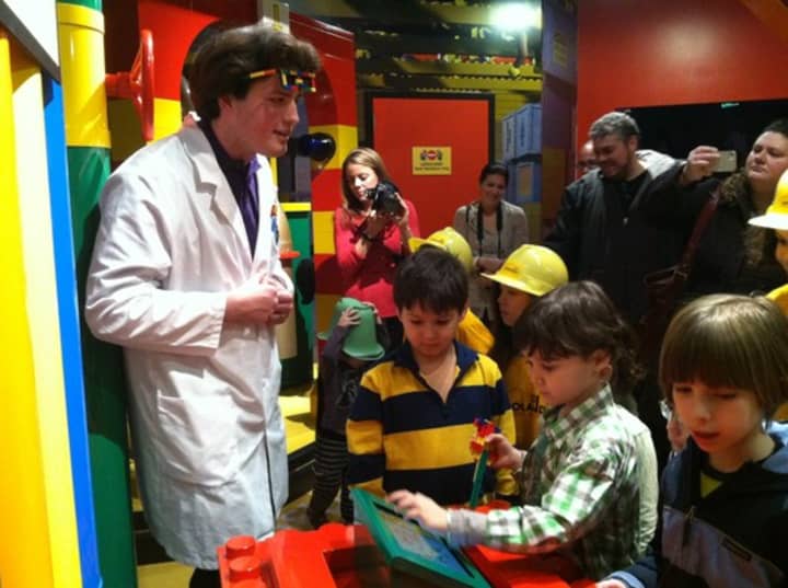 Children get an introduction to Legoland from an employee inside the factory room Thursday. 