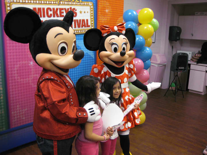 After making paper air guitars, kids meet Mickey and Minnie and get their pictures taken.