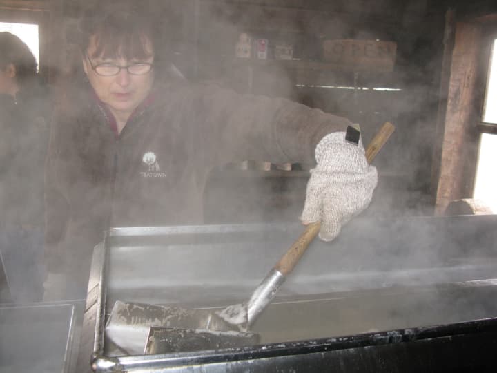Phyllis Bock checks on a batch of syrup at Ossining&#x27;s Teatown Lake Reservation.