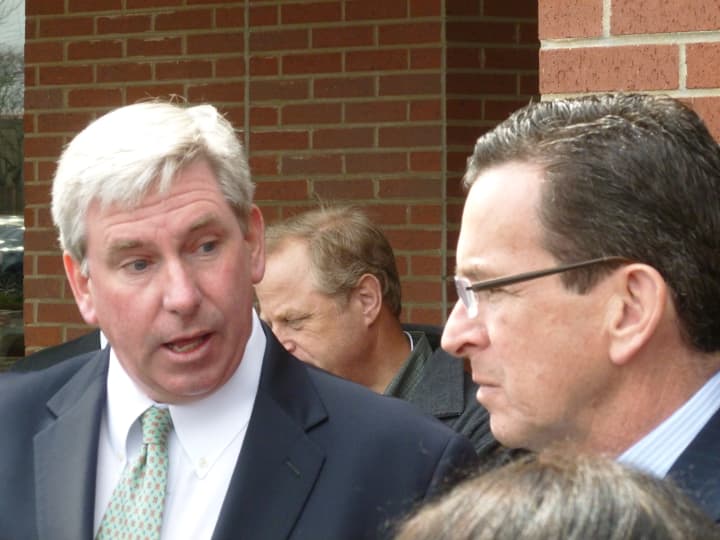 Robert Hartt, left, manager of the shopping and movie complex at 542 Westport Ave. in Norwalk, speaks to Gov. Dannel Malloy on Monday about a new energy efficient improvement project at the site.