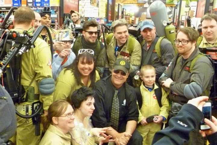 Actor Dan Aykroyd, center with sunglasses and hat, poses with a group of &quot;Ghostbusters&quot; fans at his appearance at Total Wine and More in Nowalk.