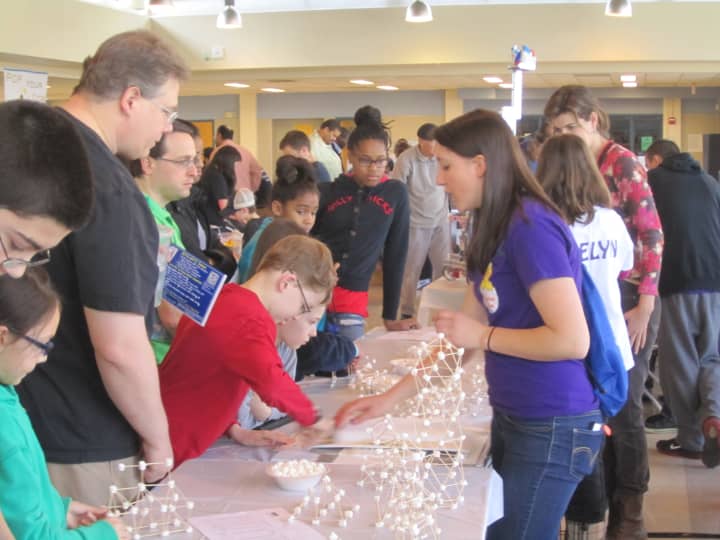 North Salem High School senior Cecilia Diehl shows kids how to construct a building using marshmallows and toothpicks at the 10th annual Lower Hudson Valley Engineering EXPO in White Plains. 